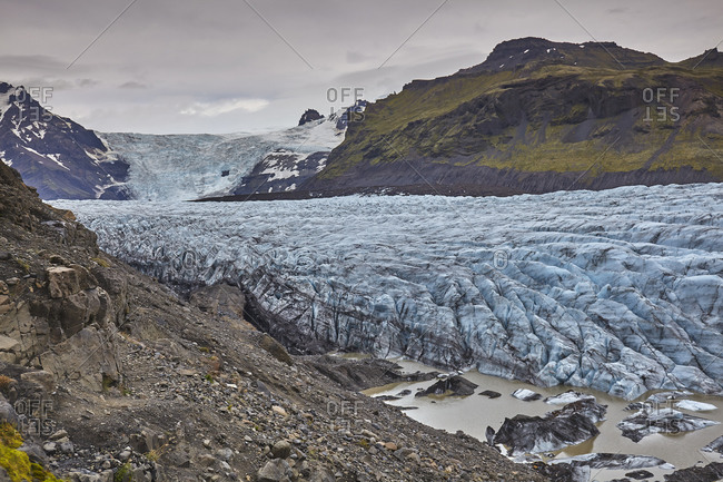 A retreating glacier, pouring down from the Vatnajokull icecap, in Skaftafell National Park, southern Iceland, Polar Regions