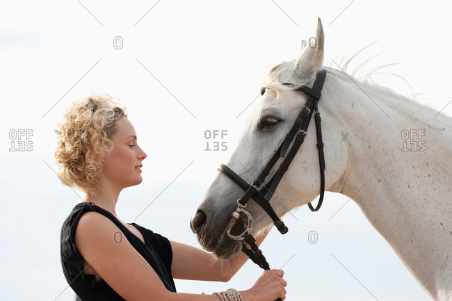 Young woman with white horse
