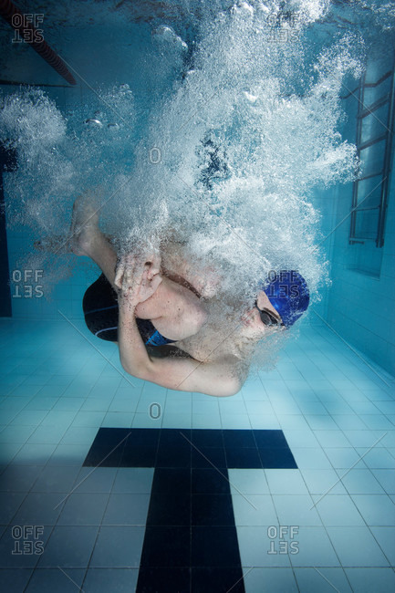 Swimmer jumping into a pool