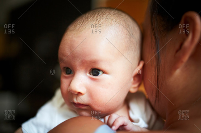 Mother holding baby son, close up