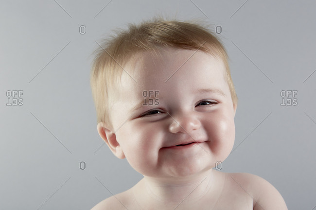 Close up studio portrait of smiling baby girl