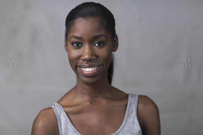 Portrait of young woman, smiling, studio shot