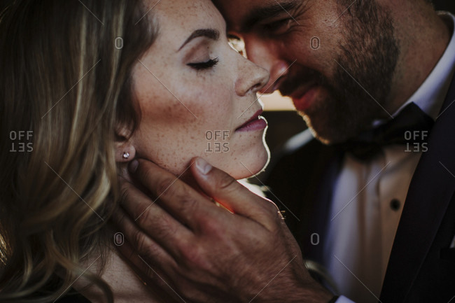 Festively dressed couple, tenderness, kiss, close-up