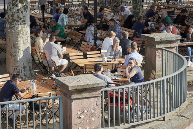 July 7, 2019: Guests in a garden restaurant on a sunny afternoon at the eiserner steg in frankfurt.