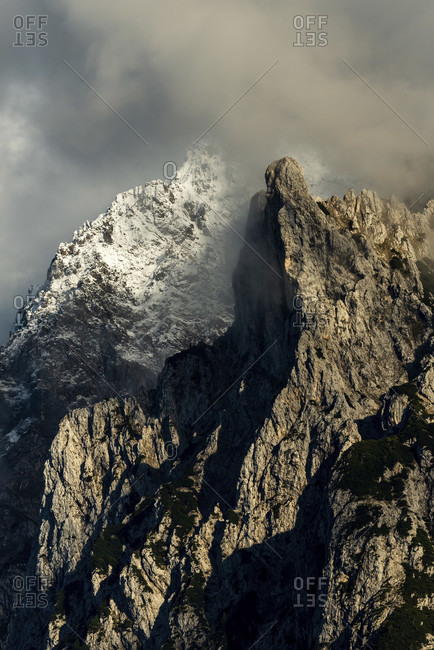 The viererspitze in the karwendel, in the background the warner with snow in the warm evening light with dramatic clouds