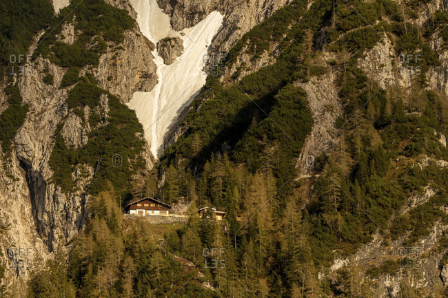 Mittenwalder hutte in the warm evening light with snow field in the background