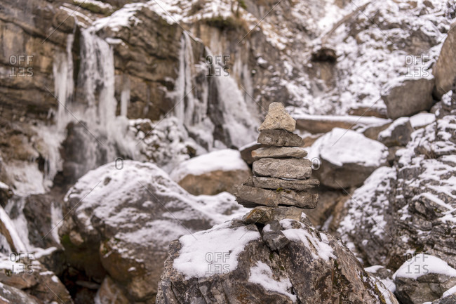 Stone marking on the kuhflucht waterfall near farchant in winter with snow and ice
