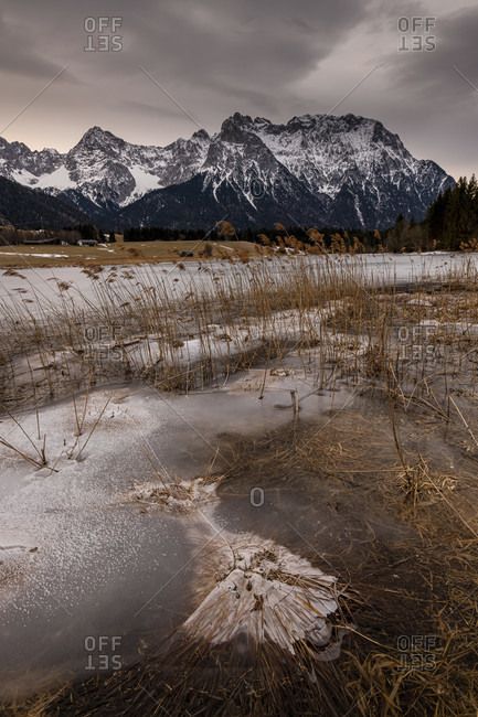 The schmalensee near mittenwald in winter, ice and reeds line the shore.