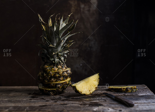 Sliced and arranged pineapple on a wooden table