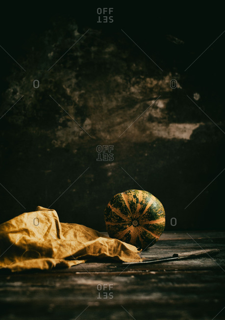 Mini round pumpkin in a dark setting