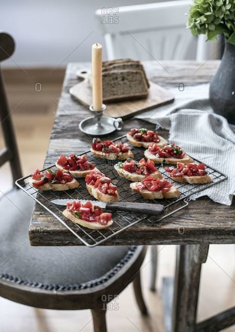 Bruschetta on cooling rack served on a wooden table