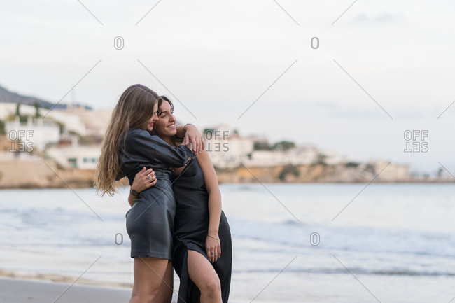 Happy gay couple spending time together in Sitges' beach, Spain