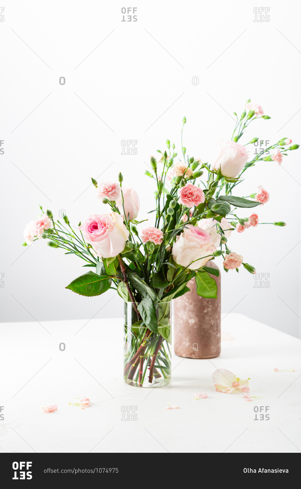 Two pink floral arrangements on a white table
