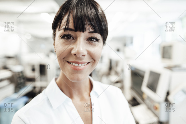 Smiling female professional with brown bangs at industry