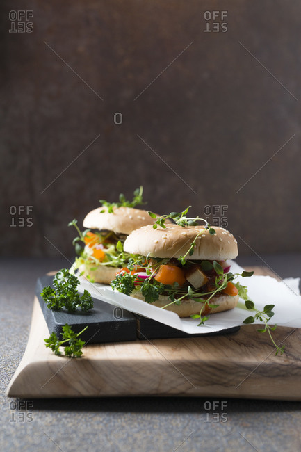 Vegan burger with soy schnitzel strips- bell pepper- radishes- oregano and lettuce