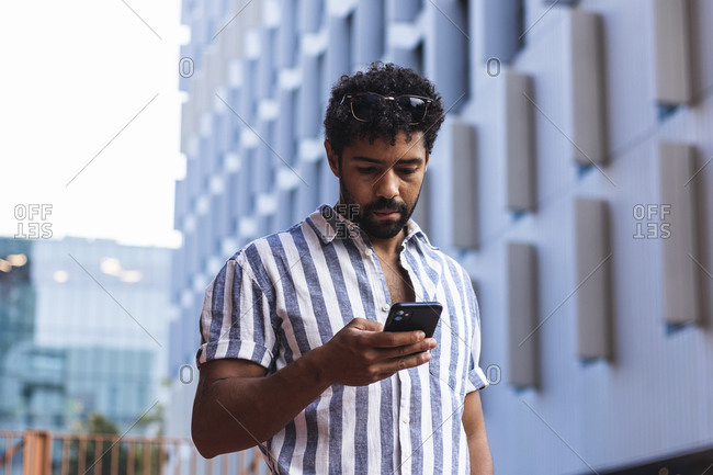 Man using smart phone while standing in city
