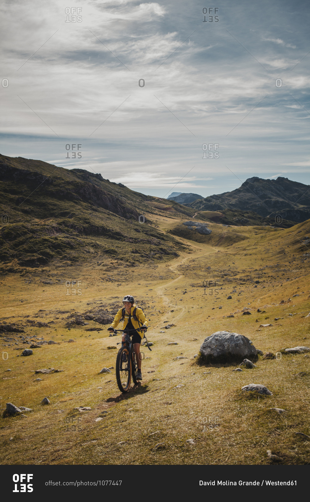 Woman riding electric bicycle on mountain at Somiedo Natural Park- Spain