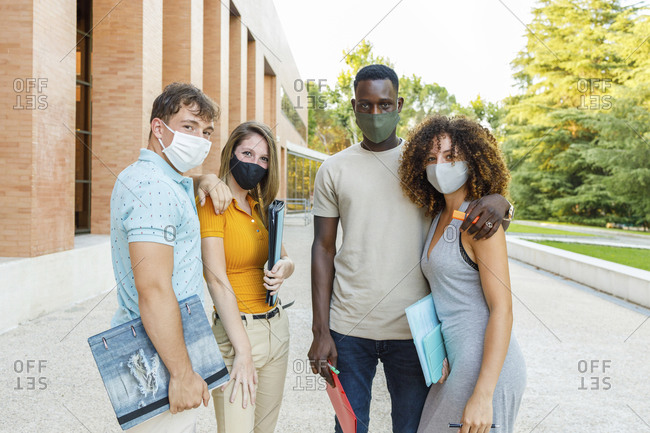 University students wearing protective face mask while standing in campus