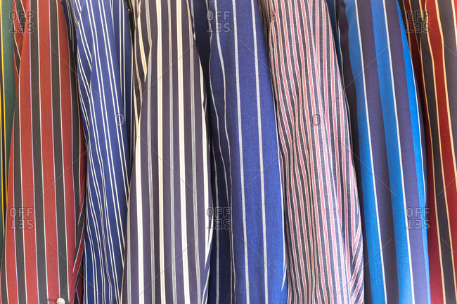 A selection of striped blazers on a rack, traditional leisure wear.