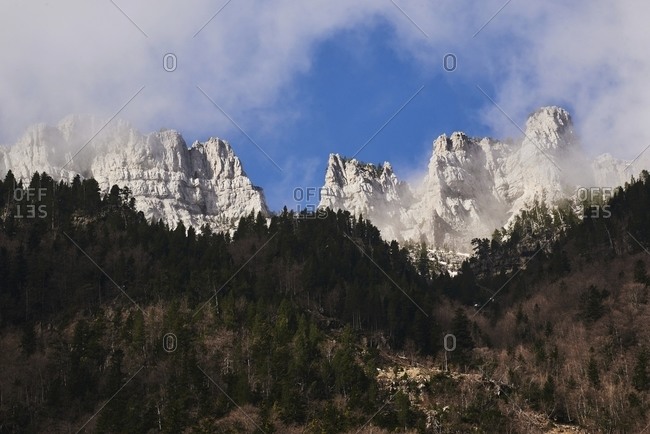 Amazing view of Pyrenees mountain range covered with snow on background of blue sky in Ordesa Valley