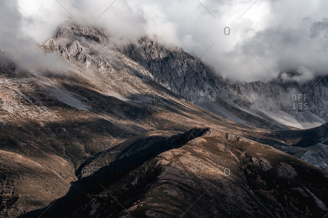 Mist landscape of mountains in autumn with cloudy sky