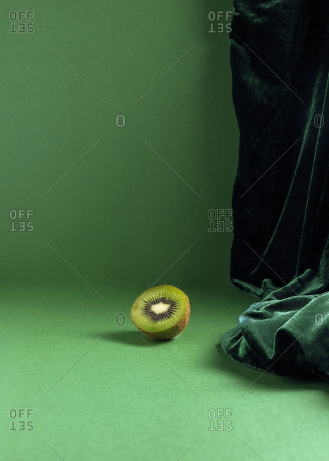From above composition of fresh natural green kiwi arranged on green background
