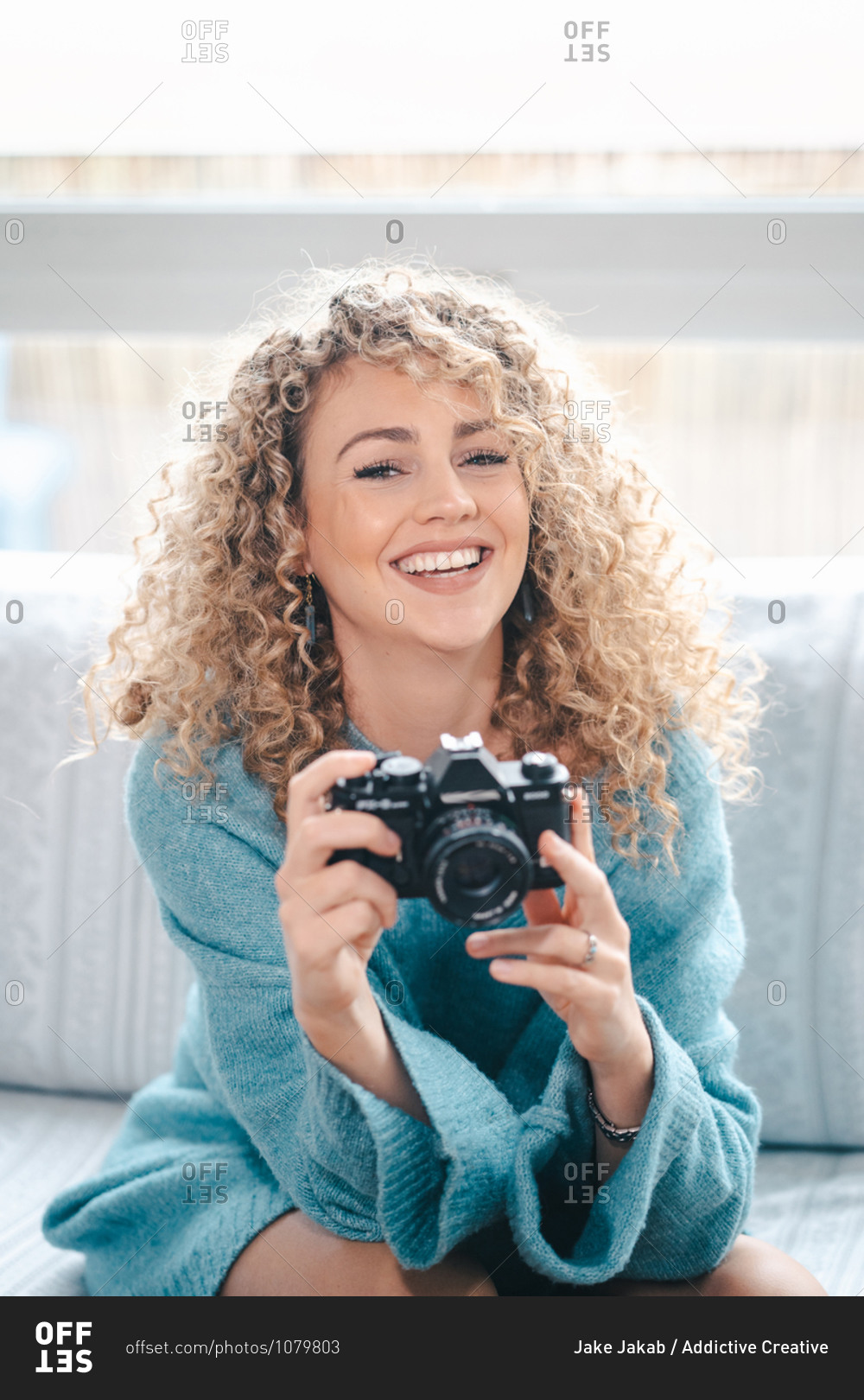 Charming Female With Curly Hair Taking Picture On Photo Camera In