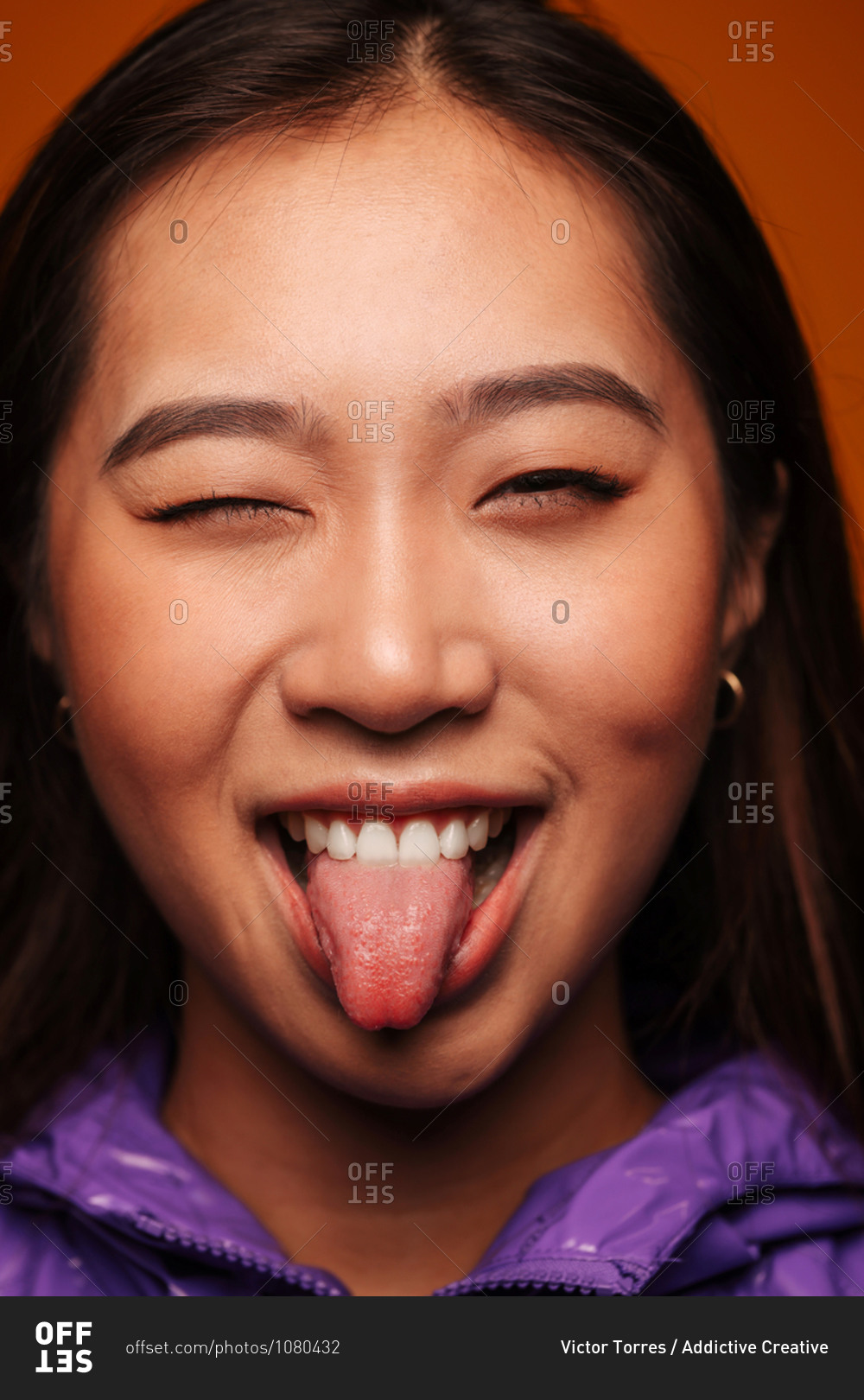 Studio Portrait Of Cute Teen Girls Sticking Out Tongue by Stocksy  Contributor VICTOR TORRES - Stocksy