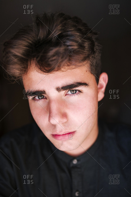 Portrait of teenage boy with black background