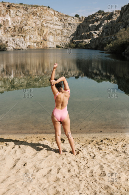 Young teenage girl in a depié swimsuit is going to bathe in a quarry of a river in Spain