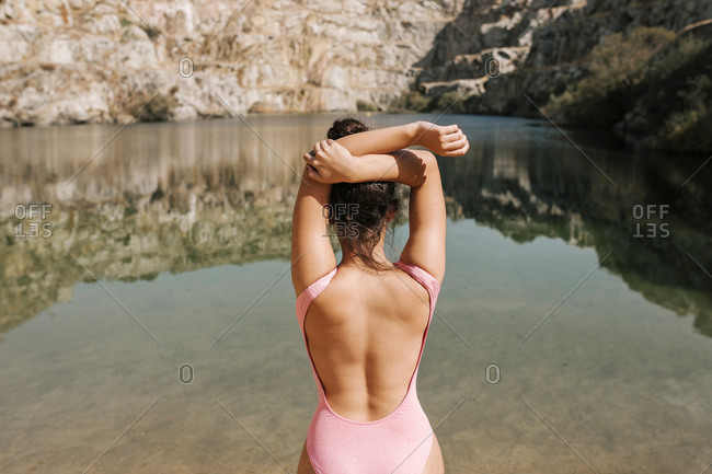 Young teenage girl in a depié swimsuit is going to bathe in a quarry of a river in Spain