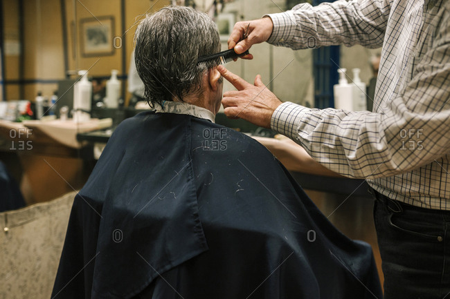 Senior man in a barber shop getting a haircut