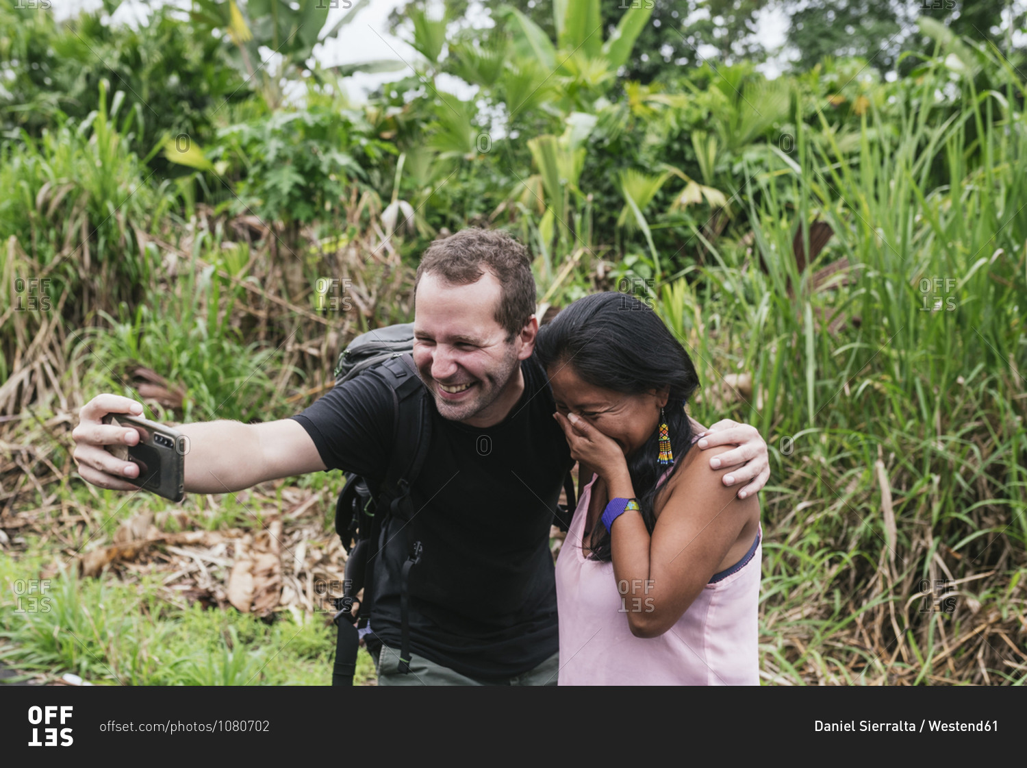 Smiling male tourist taking selfie with shy woman at Misahualli- Ecuador