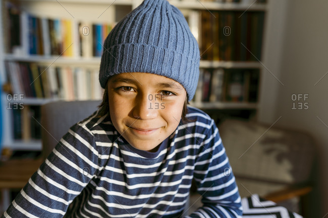 Smiling boy wearing knit hat at home