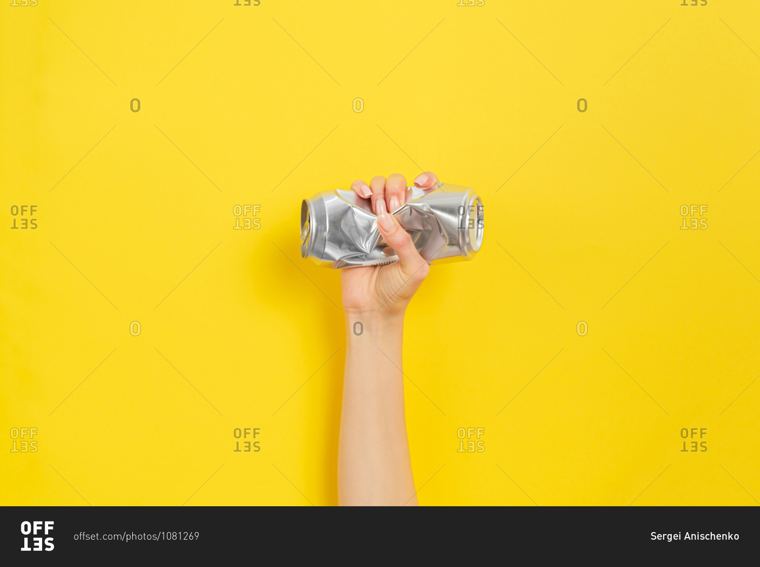 Hand clutches a crushed can as a symbol of the struggle for nature. Yellow background