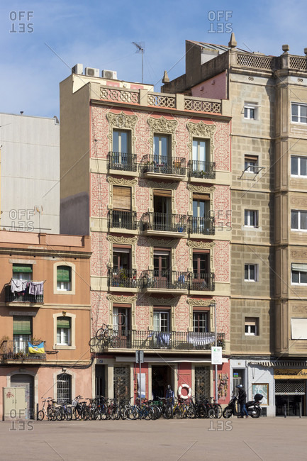 March 31, 2016: Barcelona, port district, La Barceloneta, house, facade, balconies, bicycles