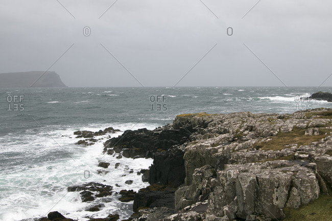 Landscape in Scotland's highlands cliff with crashing waves