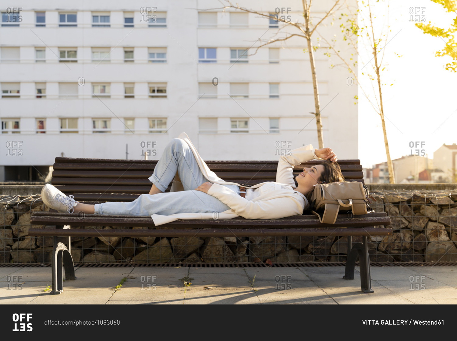 Female entrepreneur relaxing while lying down on bench
