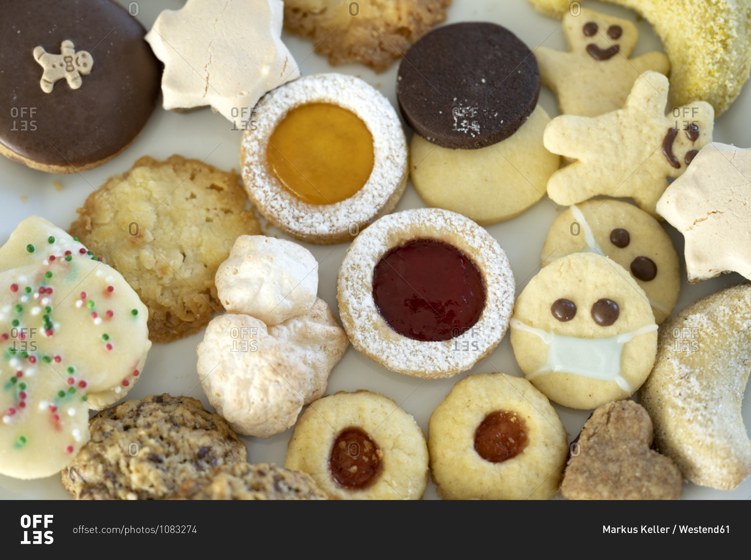 Various ready-to-eat Christmas cookies- one wearing protective face mask