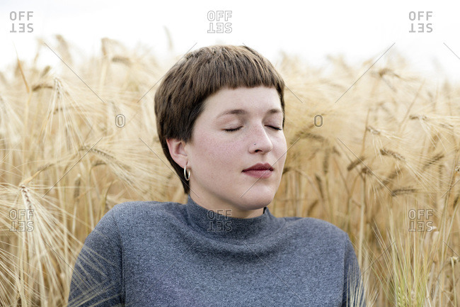 Woman dreaming against grain field