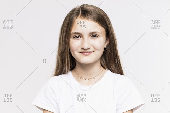 Smiling girl with brown hair against white background