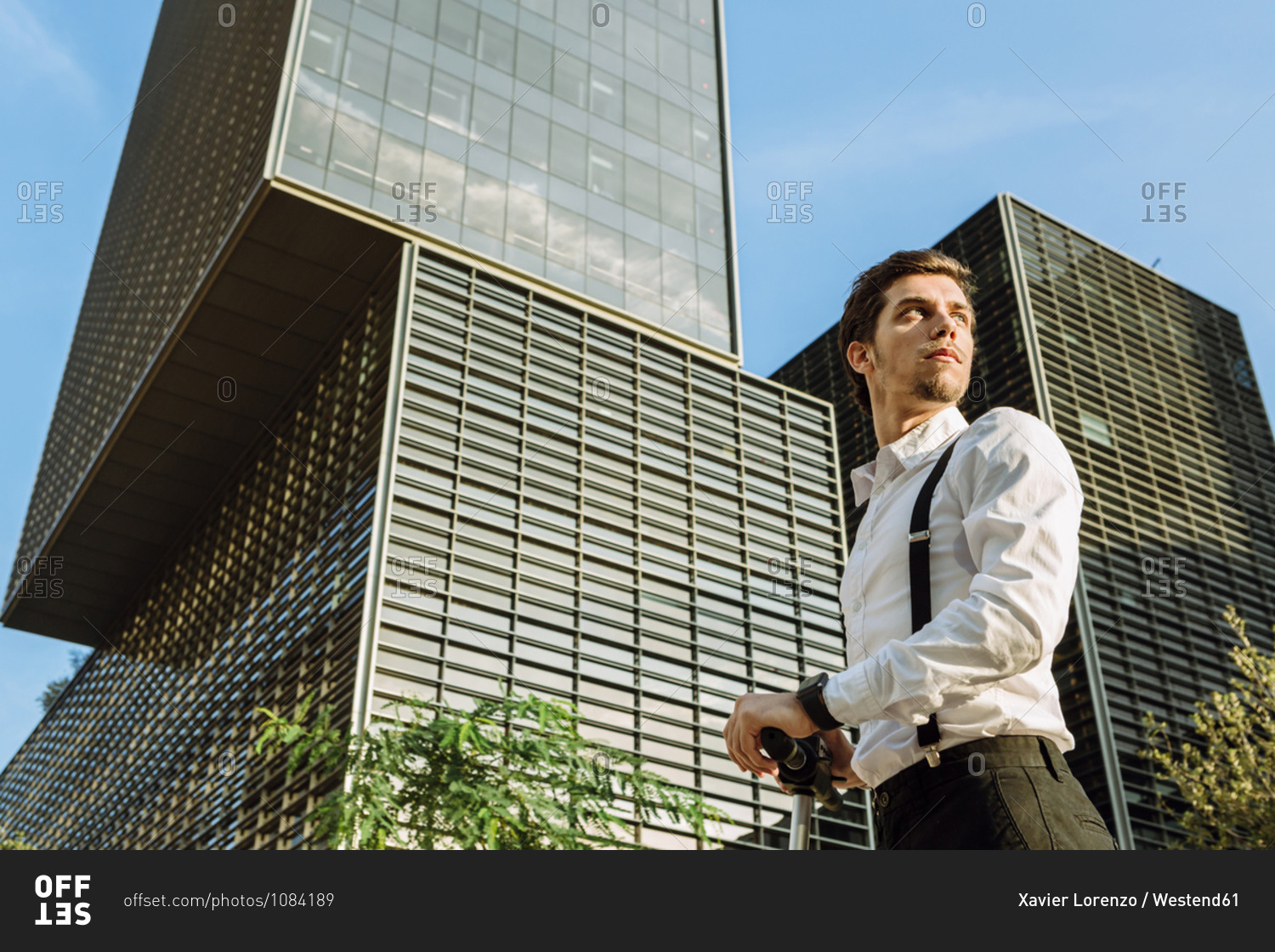 Businessman in city- office buildings in background