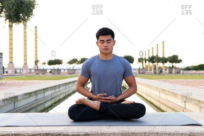 Smiling Handsome Asian Man Doing Splits On Yoga Mat Stock Photo, Picture  and Royalty Free Image. Image 73794074.