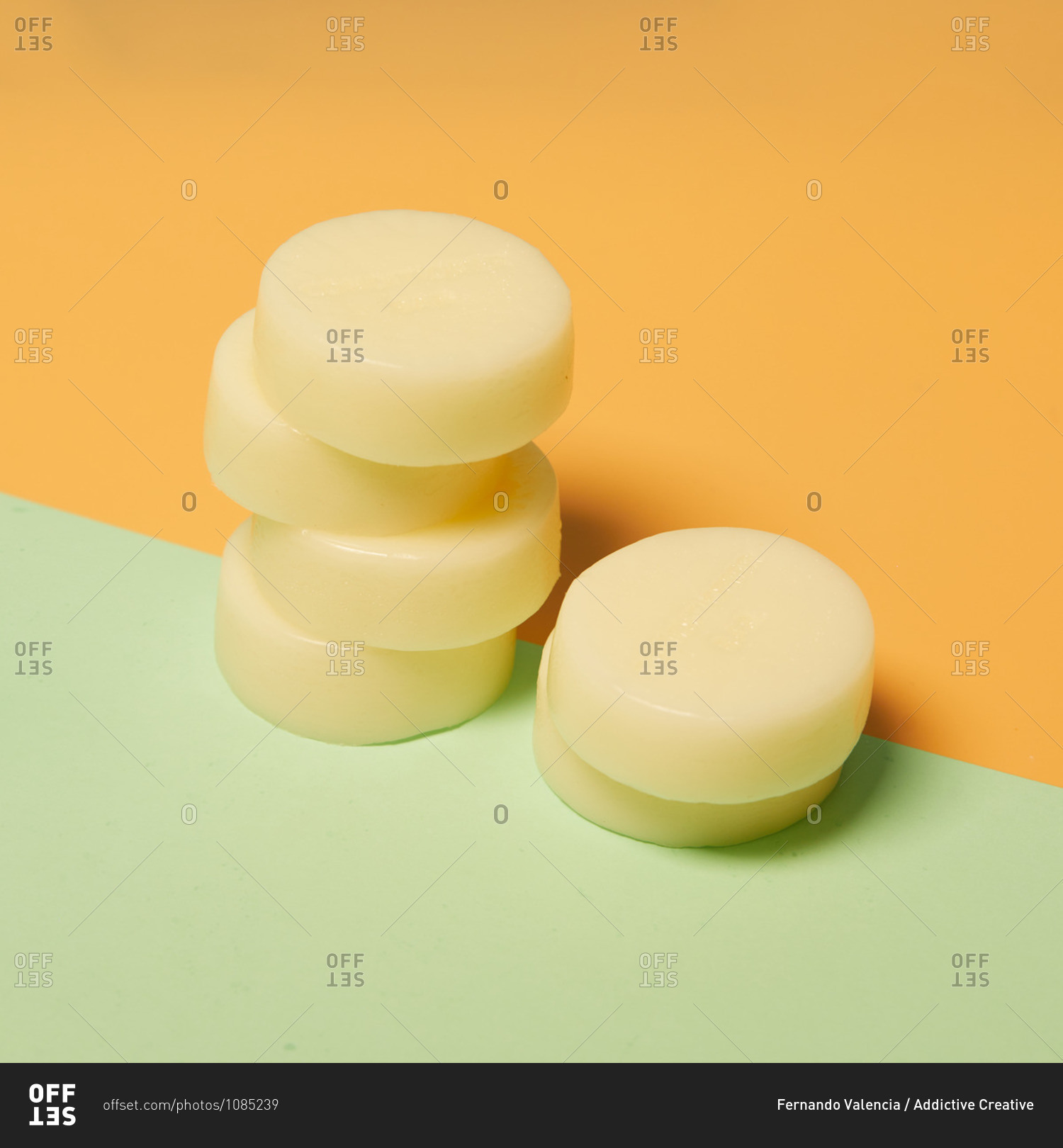 Natural round shaped soap arranged on two colored background in studio