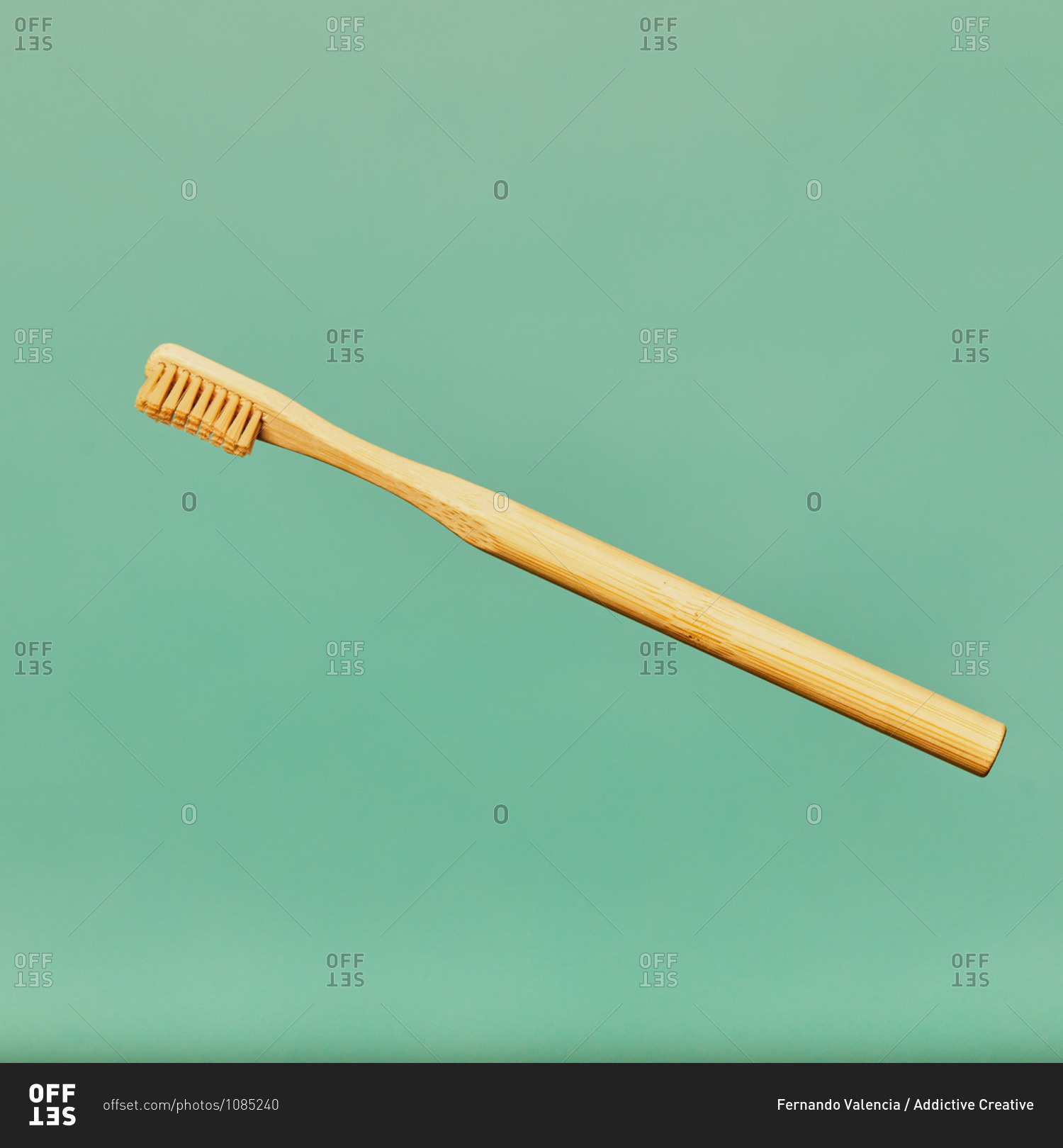 Toothbrush made of bamboo on blue background in studio showing concept