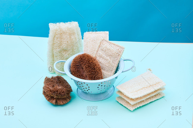 High angle of assorted eco friendly hygienic supplies for skin treatment in shower placed on blue background in studio
