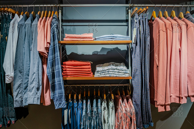 Interior detail of a modern clothing store with hanging clothes