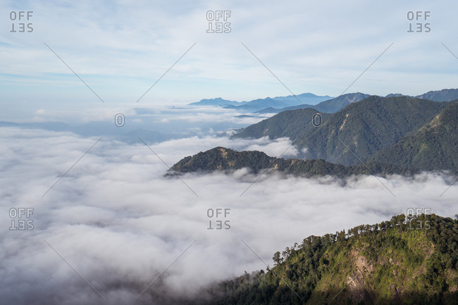 Spectacular highland landscape with Yuanzui Mountain on sunny day under cloudy sky in Taiwan