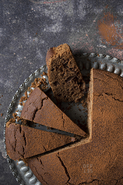 Chocolate cake slices with sifter and cocoa powder