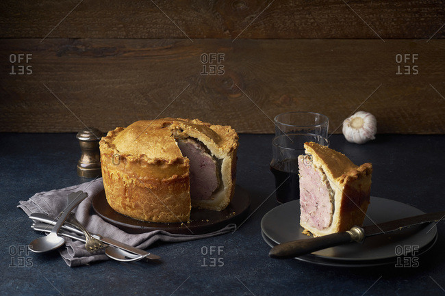 Traditional British raised pork pie with bacon and herbs